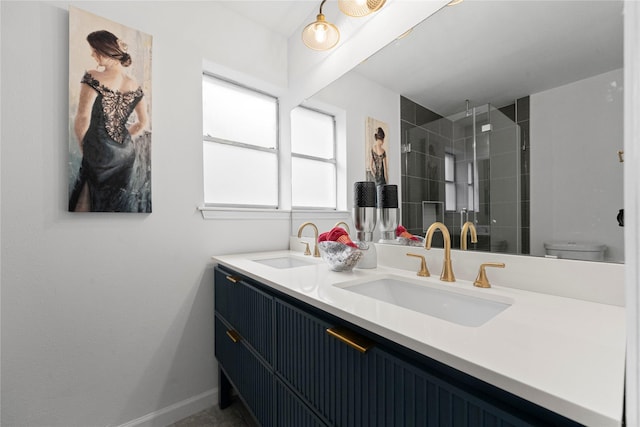 bathroom with vanity, toilet, and a shower with shower door