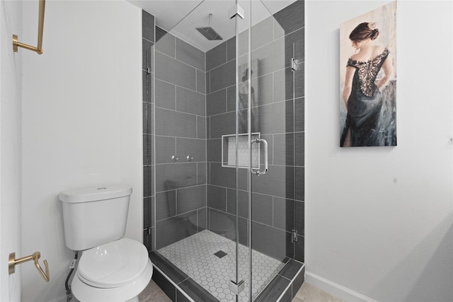 bathroom featuring an enclosed shower and toilet