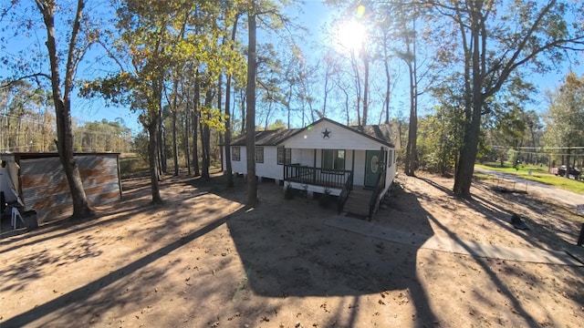 back of property featuring covered porch