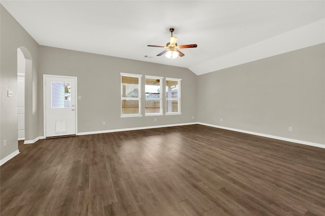 unfurnished living room featuring ceiling fan, dark hardwood / wood-style flooring, and vaulted ceiling