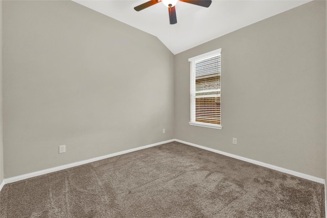 carpeted spare room featuring ceiling fan and lofted ceiling