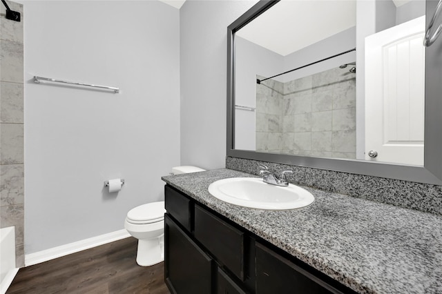 bathroom with hardwood / wood-style flooring, vanity, and toilet