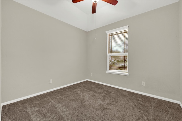 unfurnished room featuring dark colored carpet and ceiling fan