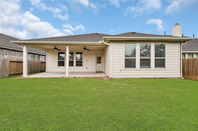 back of house with ceiling fan, a patio area, and a lawn