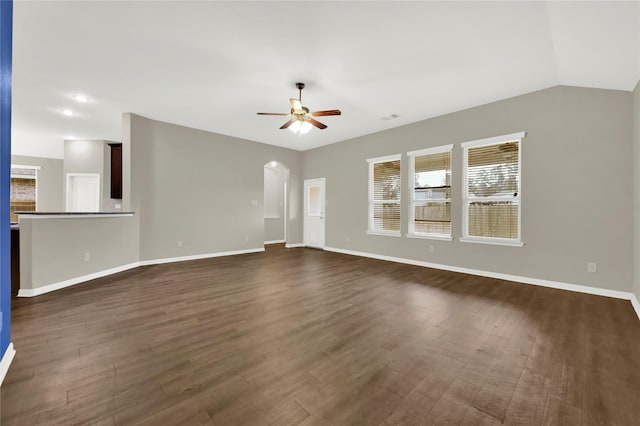 unfurnished living room with dark hardwood / wood-style flooring, vaulted ceiling, and ceiling fan