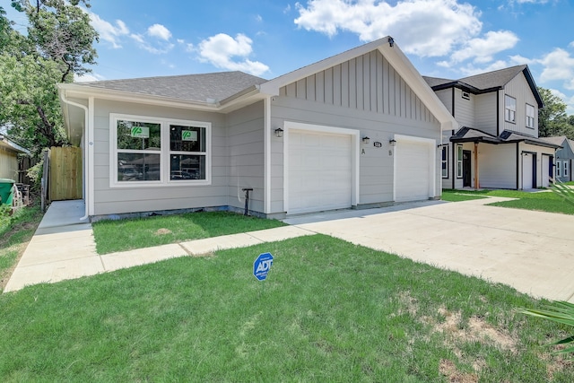 view of front of home with a front lawn and a garage