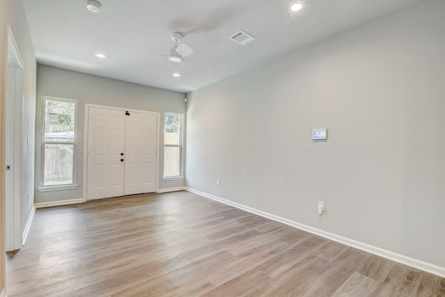 entrance foyer with ceiling fan, a healthy amount of sunlight, and light hardwood / wood-style floors