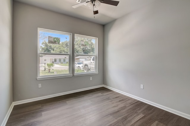 unfurnished room featuring ceiling fan and dark wood-type flooring