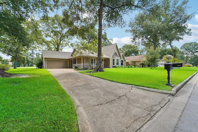 view of front of house with covered porch, a garage, and a front lawn