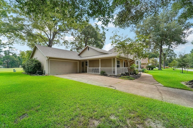 view of front of home featuring covered porch, a front yard, and a garage