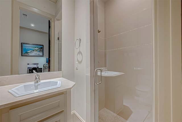 bathroom with vanity and a shower with door