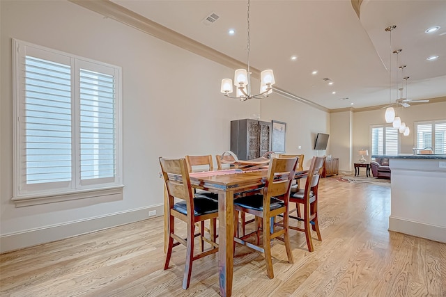 dining room featuring sink, light hardwood / wood-style floors, ceiling fan with notable chandelier, and ornamental molding