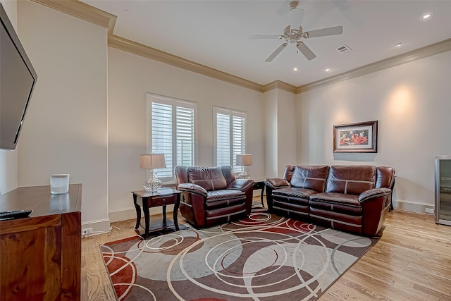 living room featuring ceiling fan, wood-type flooring, and crown molding