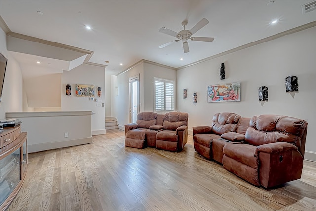 living room with ceiling fan, light hardwood / wood-style floors, and ornamental molding