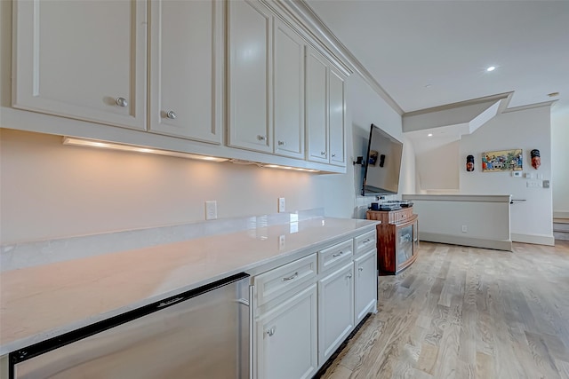 kitchen with light hardwood / wood-style flooring, white cabinetry, and ornamental molding