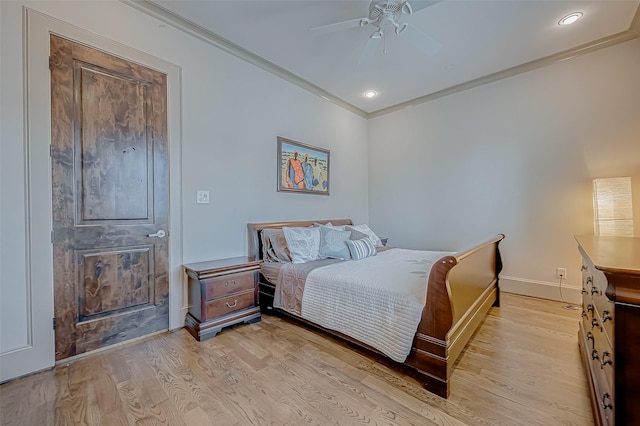 bedroom with ceiling fan, crown molding, and light wood-type flooring