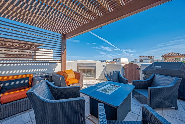 view of patio / terrace with an outdoor living space with a fireplace and a pergola