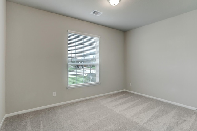 unfurnished room with light colored carpet