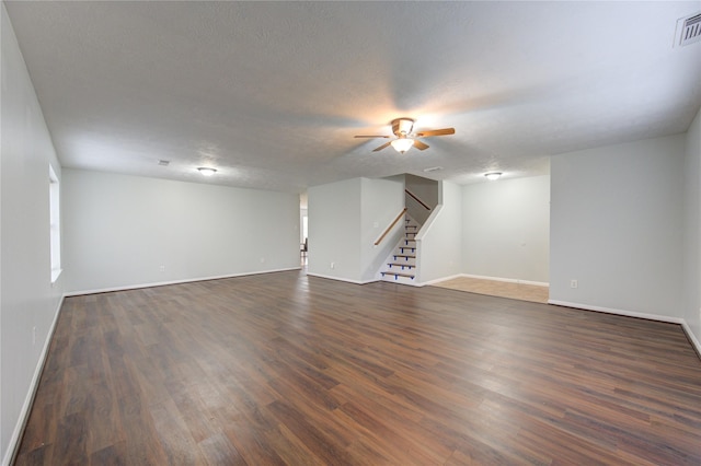 interior space featuring ceiling fan, dark hardwood / wood-style flooring, and a textured ceiling