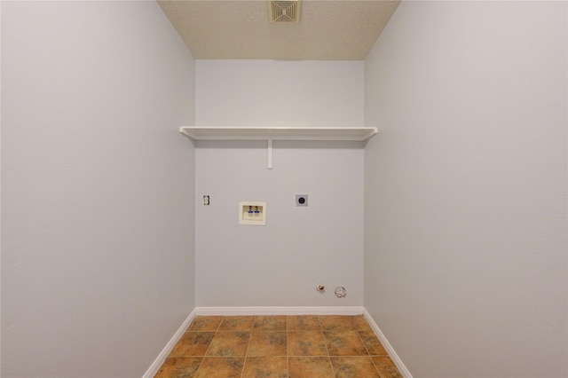 laundry room with electric dryer hookup, gas dryer hookup, hookup for a washing machine, and a textured ceiling