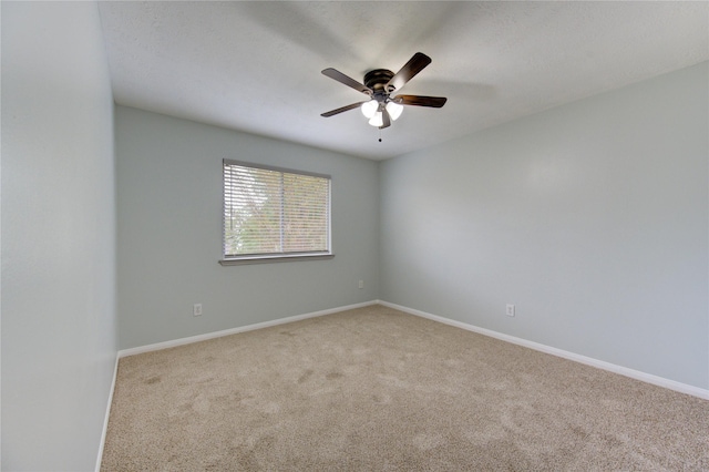 spare room with light carpet and ceiling fan