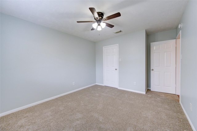 unfurnished bedroom featuring ceiling fan and light carpet