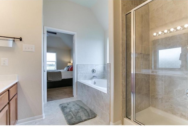 bathroom featuring tile patterned flooring, vanity, lofted ceiling, and shower with separate bathtub