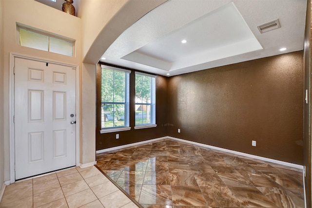 entrance foyer with a raised ceiling