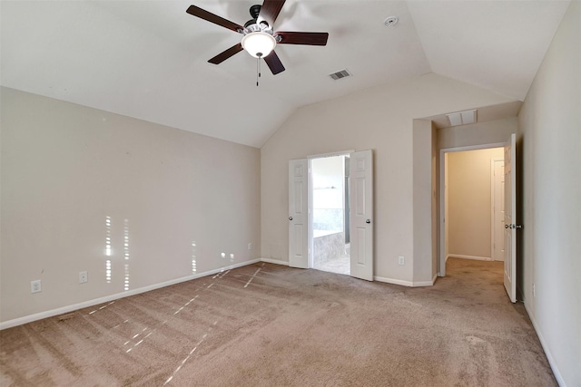 unfurnished bedroom featuring ceiling fan, carpet, ensuite bathroom, and lofted ceiling