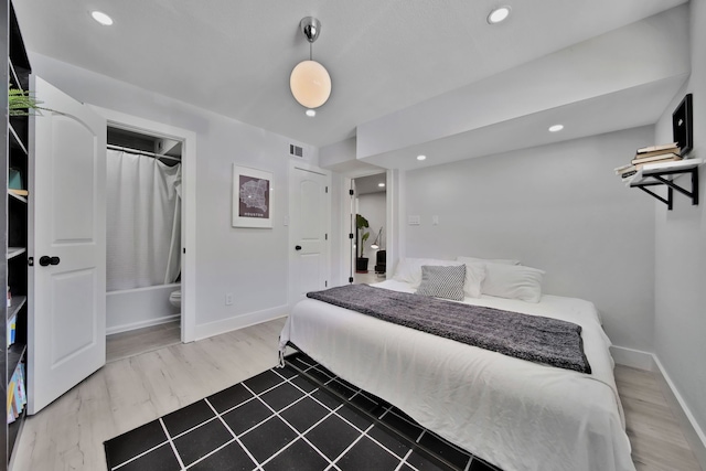 bedroom featuring dark wood-type flooring and a closet