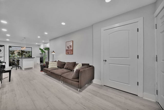 living room featuring light hardwood / wood-style floors and stacked washer and clothes dryer