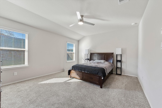 bedroom with ceiling fan, vaulted ceiling, and light carpet