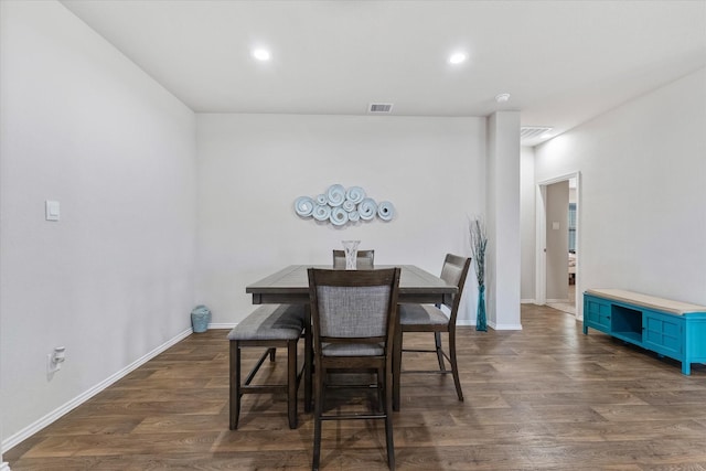 dining room with dark hardwood / wood-style flooring