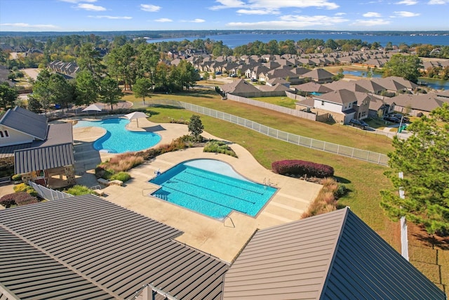 view of swimming pool featuring a patio area and a water view