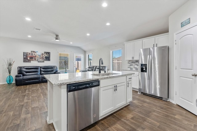 kitchen with white cabinetry, a kitchen island with sink, sink, dark wood-type flooring, and appliances with stainless steel finishes