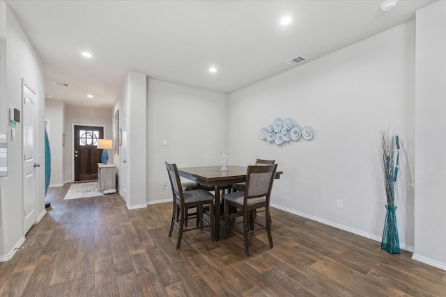 dining area with dark hardwood / wood-style flooring