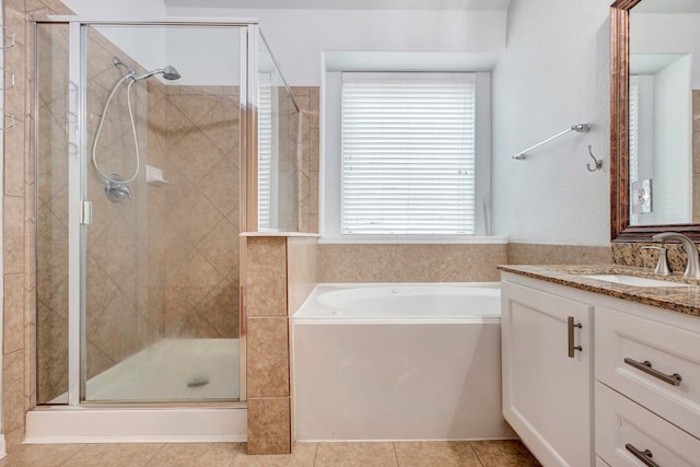 bathroom with tile patterned floors, vanity, and separate shower and tub