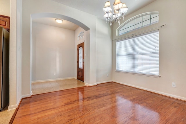 entrance foyer featuring an inviting chandelier and light wood-type flooring