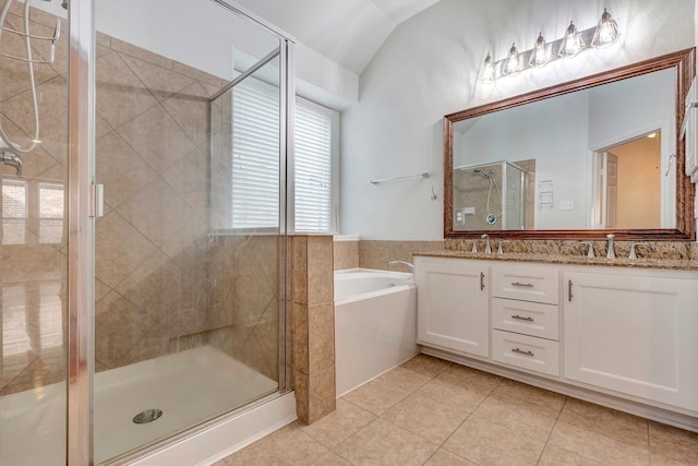 bathroom with tile patterned floors, shower with separate bathtub, and vaulted ceiling