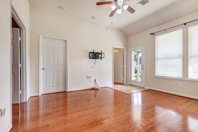 unfurnished room with lofted ceiling, hardwood / wood-style flooring, and ceiling fan