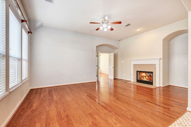 unfurnished living room with ceiling fan and wood-type flooring