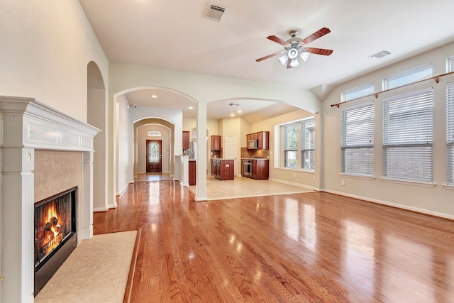 unfurnished living room with light hardwood / wood-style flooring and ceiling fan