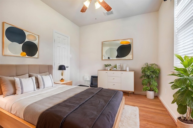 bedroom with ceiling fan and light hardwood / wood-style flooring