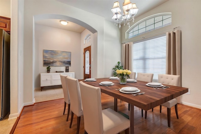 dining area featuring light hardwood / wood-style floors and a notable chandelier