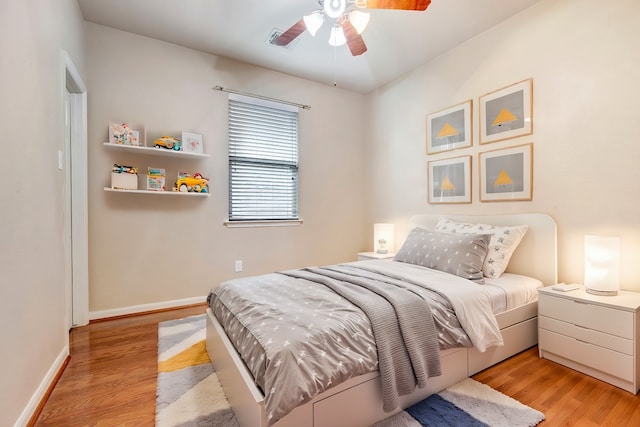 bedroom with ceiling fan and light wood-type flooring