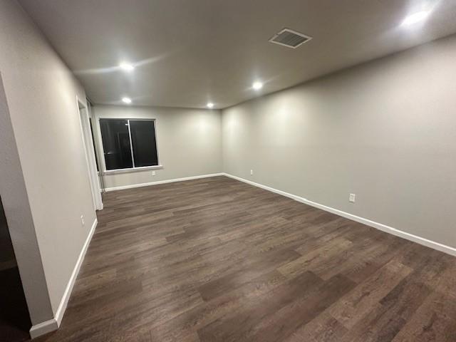 unfurnished room featuring dark hardwood / wood-style floors