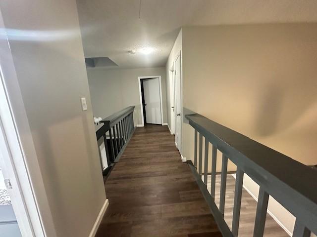 corridor with dark wood-type flooring