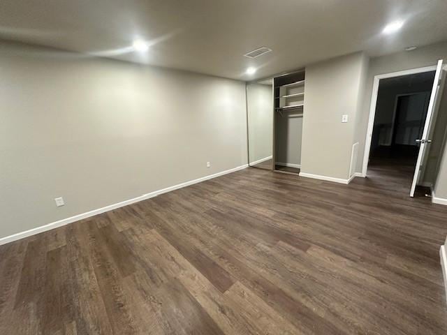 unfurnished bedroom with dark wood-type flooring and a closet