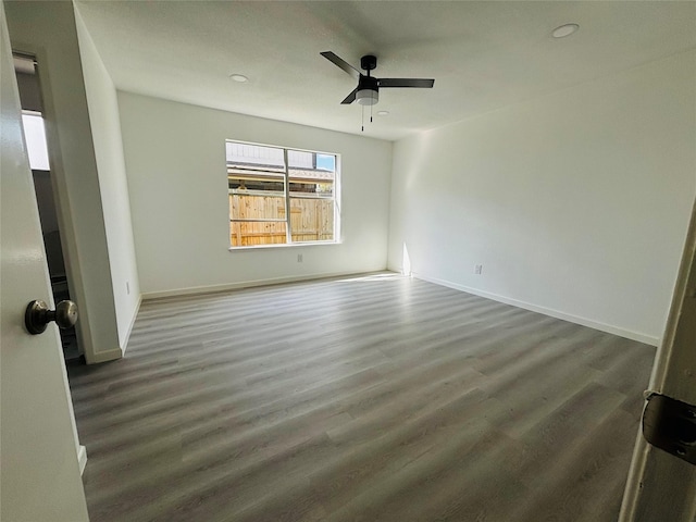 unfurnished room featuring dark hardwood / wood-style floors and ceiling fan