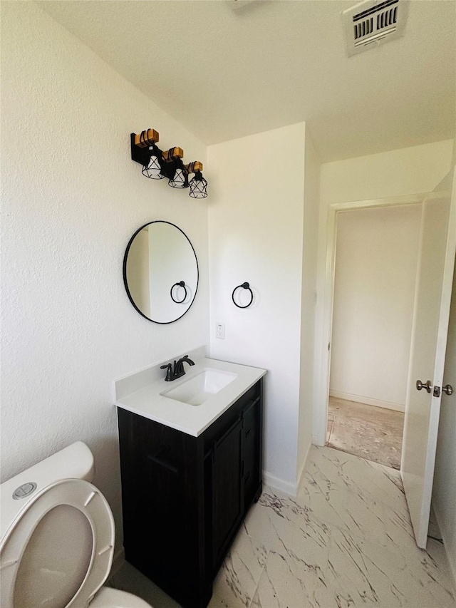 bathroom with vanity and toilet